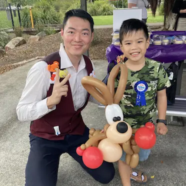 joy joe and a birthday party boy holding a kangaroo balloon twisting animal